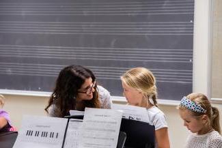 Children and teacher at a music stand